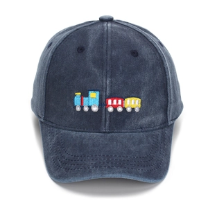 Detailed view of colorful train embroidery on navy washed cotton kids baseball cap