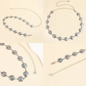 Detailed views of Bohemian metal waist chain with turquoise insets and floral relief patterns