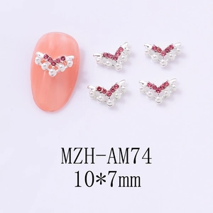 Detail of silver V-shaped nail art jewelry with pink rhinestones and 10x7mm white pearls