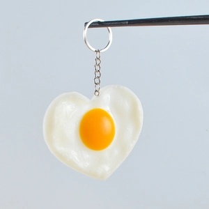 Realistic heart-shaped fried egg keychain made of PVC with silver metal ring