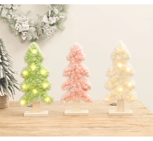 Three felt Christmas trees in green, pink, and white with LED lights on wooden bases