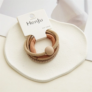 Detail of high-elasticity brown hair bands set with matte bead on minimalist tray