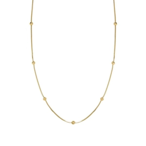 Detailed close-up of golden beaded snake chain necklace featuring minimalist choker design