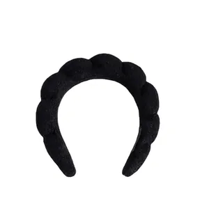 Close-up detail of a thick black braided sponge headband for face washing and styling