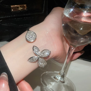 Detailed macro of silver butterfly open bracelet with sparkling micro-pave zirconia crystals