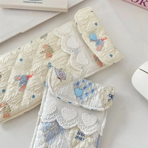 Detailed view of quilted cotton pouches featuring lace trim and cute heart buttons