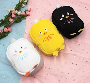 Detailed embroidery on soft plush duck cosmetic bags in black, yellow and white colors