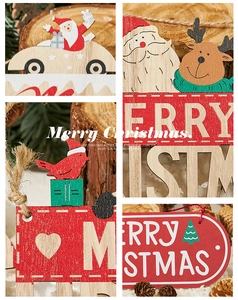 Macro detail of laser-cut wooden Merry Christmas ornaments with Santa and reindeer