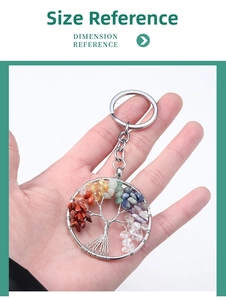 Detail of Tree of Life keychain with colorful natural crystal stones held in hand