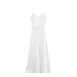 Detailed close-up of a white satin midi slip dress with thin straps and deep V-back