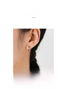 Detail of colorful enamel link hoop earrings in minimalist silver chain design on model