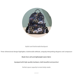 Detail of floral and bird embroidery on lightweight navy nylon backpack for women