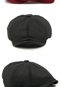 Detail of black newsboy cap featuring multi-panel stitching and textured fabric finish