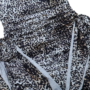 Detailed macro view of leopard print fabric texture and ruched stitching details