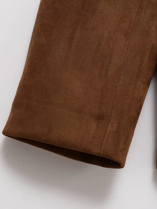 Detail of sleeve cuff stitching and premium brown suede fabric texture on jacket