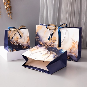 Three royal blue marble gift bags with elegant silk handles and sweet times print