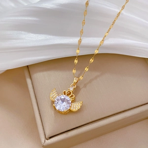 Detail of gold crown angel wing necklace featuring a large round zircon on silk