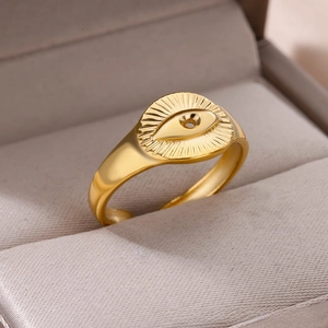 Detail of adjustable golden angel eye ring with sunburst pattern in a jewelry box