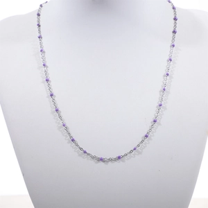 Detail of silver stainless steel bead chain with purple enamel round beads on a bust