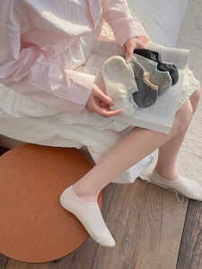 Close-up of breathable cotton no-show socks with delicate embroidered bow details