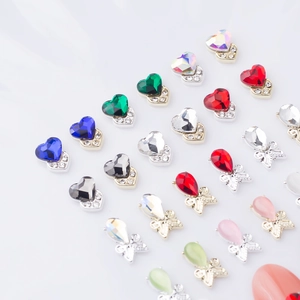 Macro shot of 3D cat eye heart and butterfly nail gems with sparkling alloy bases