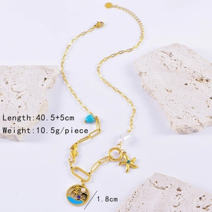 Macro detail of ocean-themed gold necklace with seahorse, starfish and turquoise charms