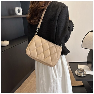 Chic beige quilted padded shoulder bag for women with minimalist winter fashion style