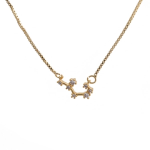 Close-up of gold Scorpio zodiac pendant with sparkling zircon stones on box chain necklace