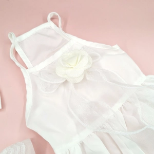 Close-up of white floral pet dress with 3D flower applique and sheer mesh texture