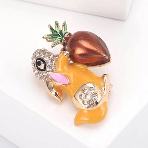 Detail of cute golden rabbit brooch with enamel carrot and sparkling rhinestones