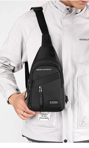 Detail view of durable black nylon crossbody chest bag with adjustable strap on model