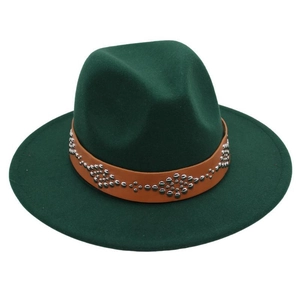Macro detail of dark green felt fedora hat with brown leather band and silver studs