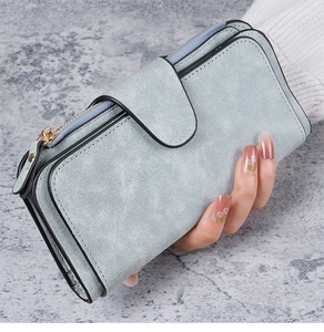 Close-up of light blue long women's wallet with buckle closure and matte PU leather texture