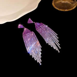 Macro shot of gradient purple rhinestone tassel earrings with a brilliant sparkling effect
