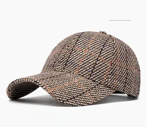 Detailed view of khaki plaid tweed baseball cap featuring textured houndstooth fabric