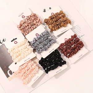 Detailed view of 21 pieces satin scrunchies set in multi-color on display cards