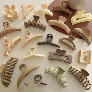 Detailed macro view of matte Morandi colored resin hair claws in various flower shapes