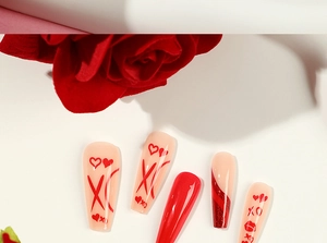 Detail of red French heart and lip print coffin press-on nails with red glitter accent
