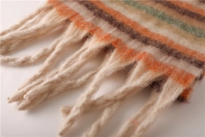 Macro shot of soft fringe tassels on a multi-color striped winter knit scarf