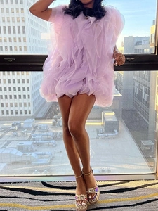Ethereal purple ruffled mesh mini dress with layered design shown on a model by the window