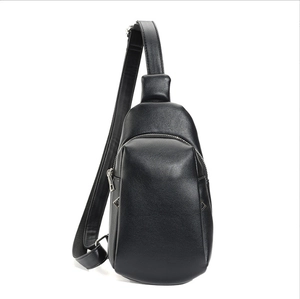 Minimalist black leather chest bag for women with teardrop shape and adjustable strap