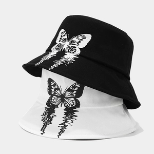 Fashionable black and white bucket hats with butterfly graphic and dissolved effect design