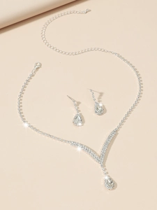 Close-up of silver teardrop rhinestone necklace and pear-shaped earrings bridal set