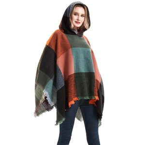 Women's hooded poncho cape with large plaid pattern and decorative fringe details