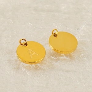 Golden stainless steel round pendant with letter A engraving and one blank charm
