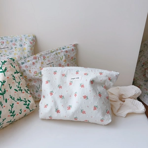 Detailed view of floral cotton makeup bags with zippers and simple wish label