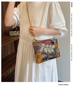 Detail of floral embroidery and colorful sequins on a premium vintage envelope clutch bag