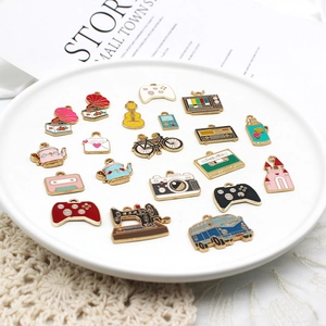 Close-up of vintage alloy drip oil pendants including camera and bicycle for DIY jewelry