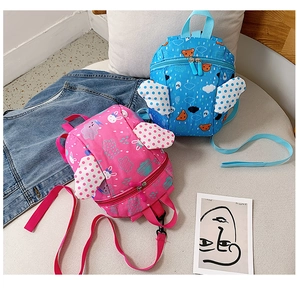 Detail view of toddler backpack showing safety harness leashes and cute angel wing patterns