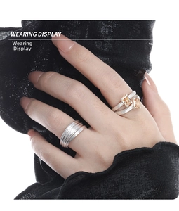 Detail of stacked S925 silver double-layer hollow rings with amber gemstones on hand